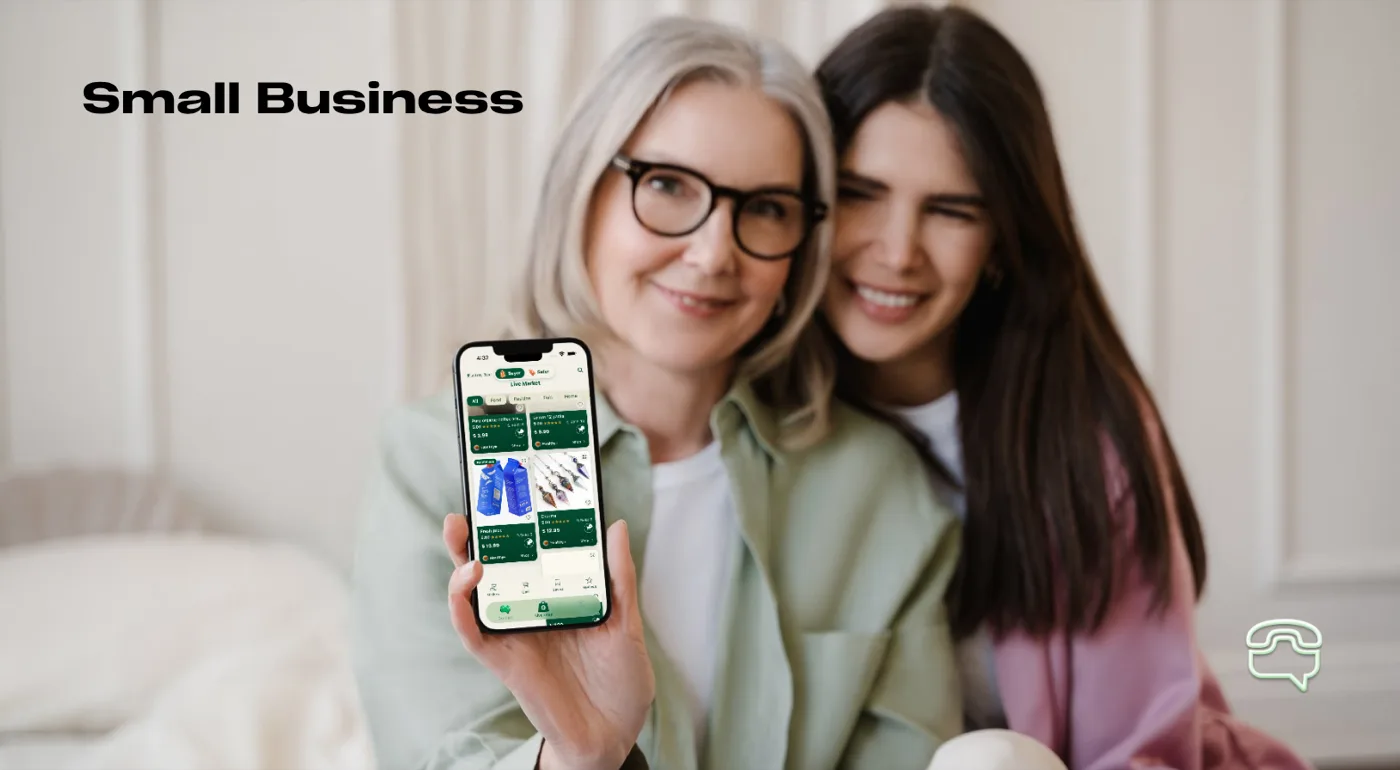 Small Business — two shopkeepers holding a phone showing their Cyca market